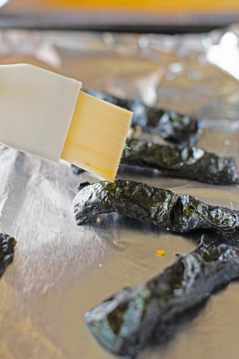 coating nori chip with sesame oil with pastry brush