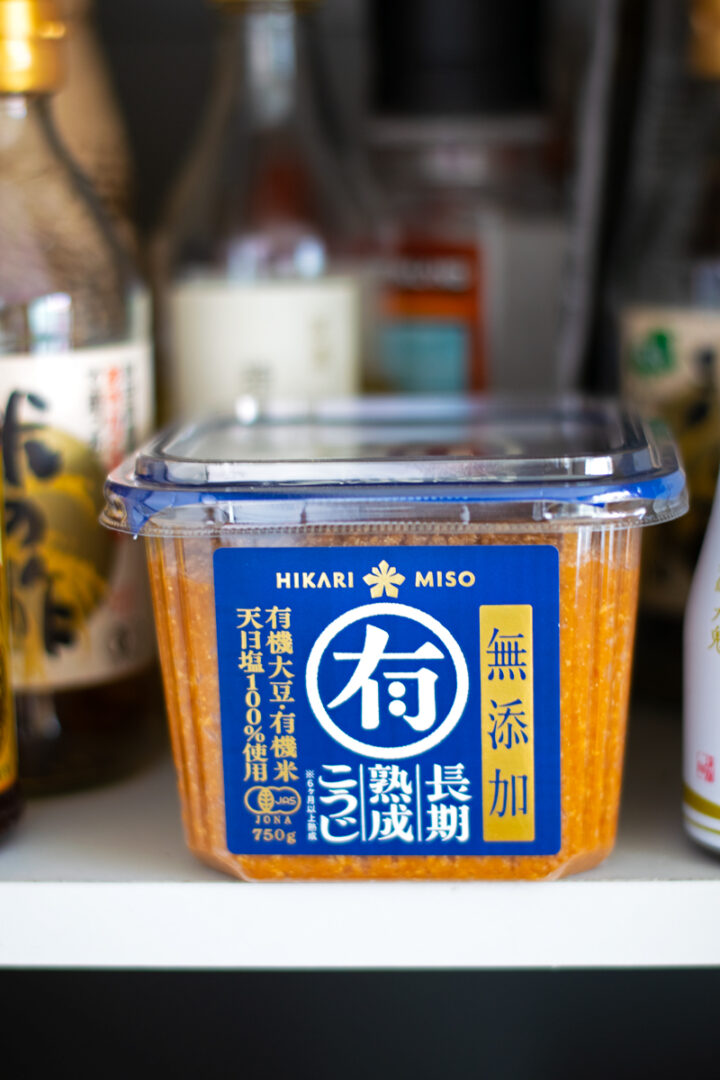 unopened miso container stored in a kitchen cabinet