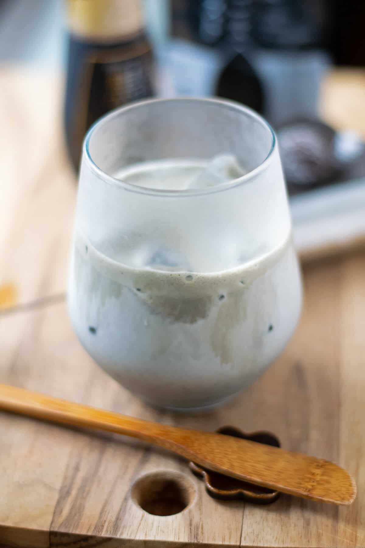 A frosted glass of iced black sesame latte with kuromitsu.