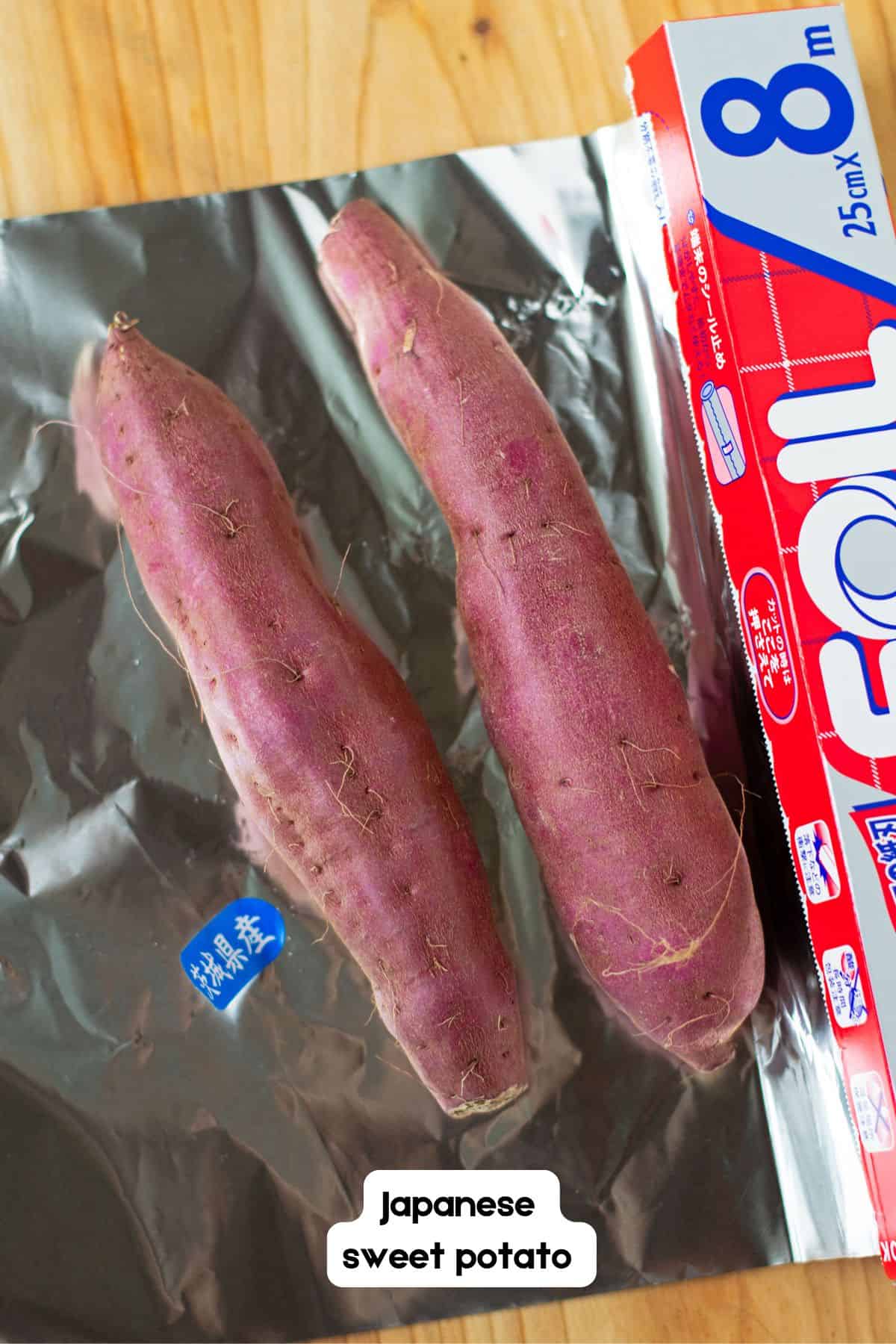 Two Japanese sweet potatoes on top of sheet of aluminum foil