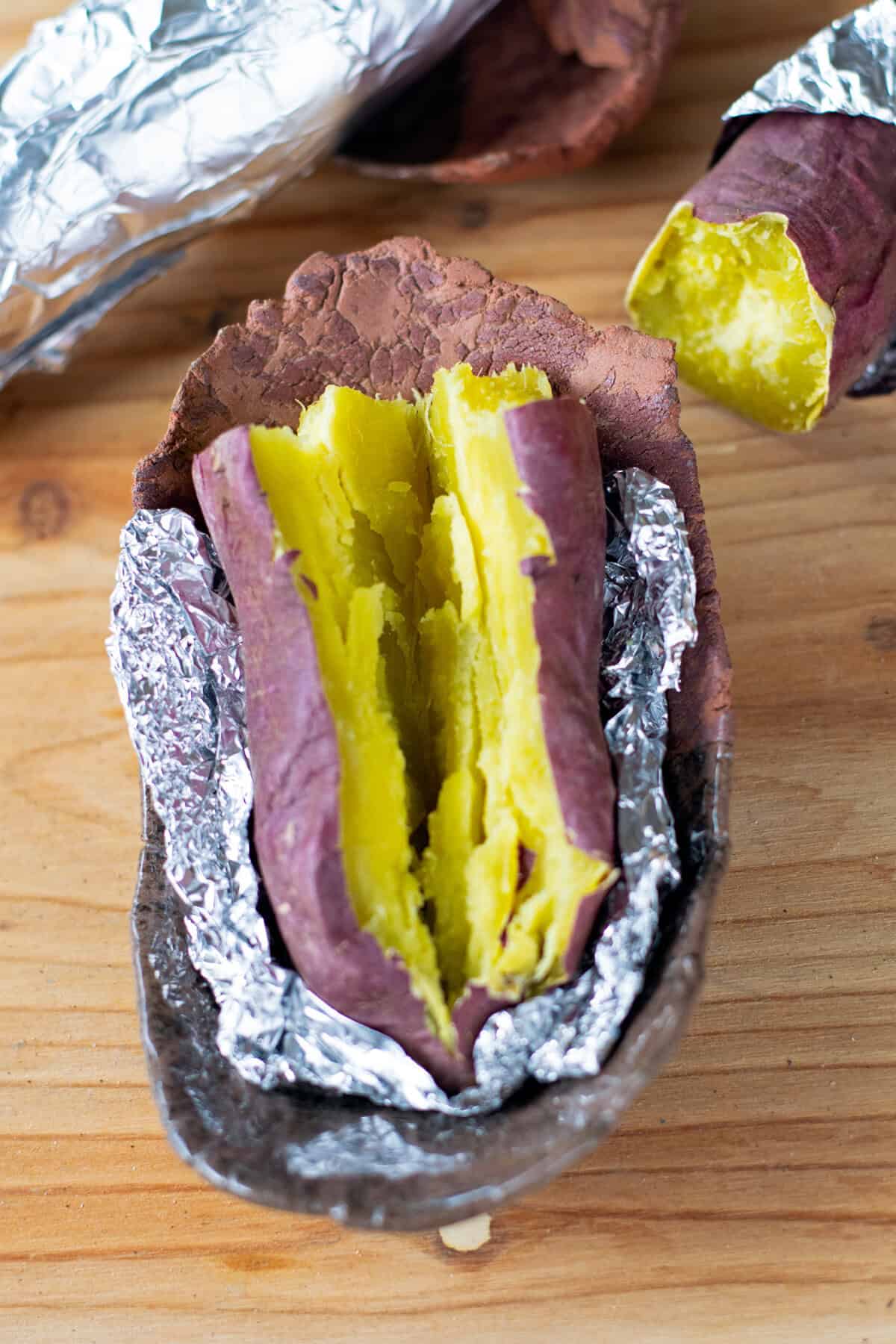 Japanese sweet potato, cut open, and wrapped in foil.