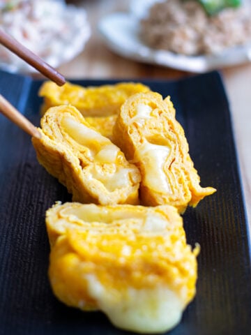 Japanese-style rolled omelet Tamagoyaki with oozing cheese