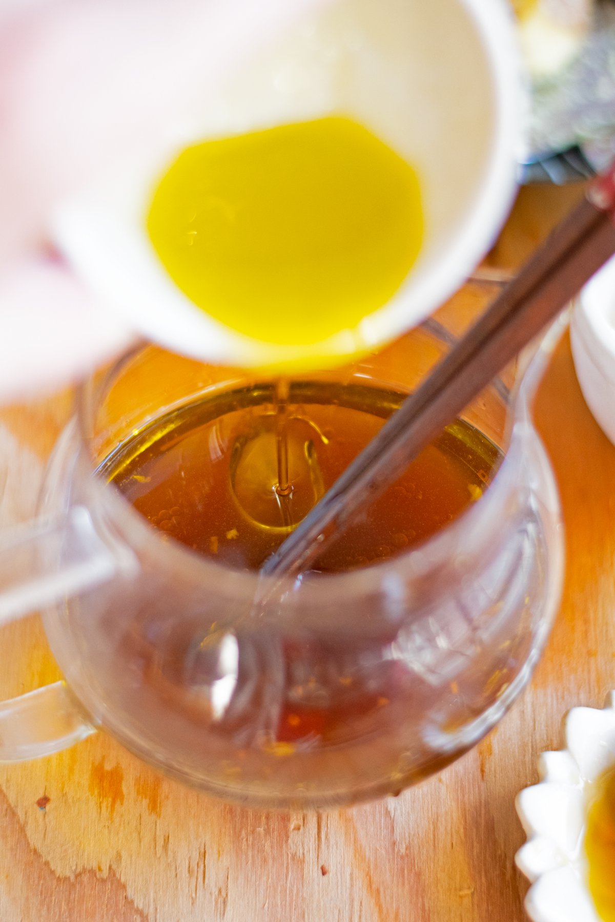 Pouring olive oil in yuzu dressing base.