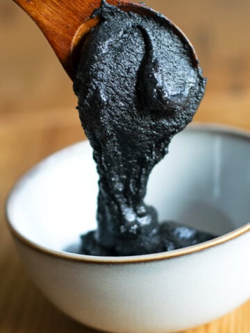 Black sesame paste spooned into a bowl.