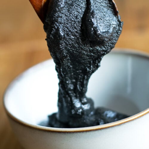Black sesame paste spooned into a bowl.