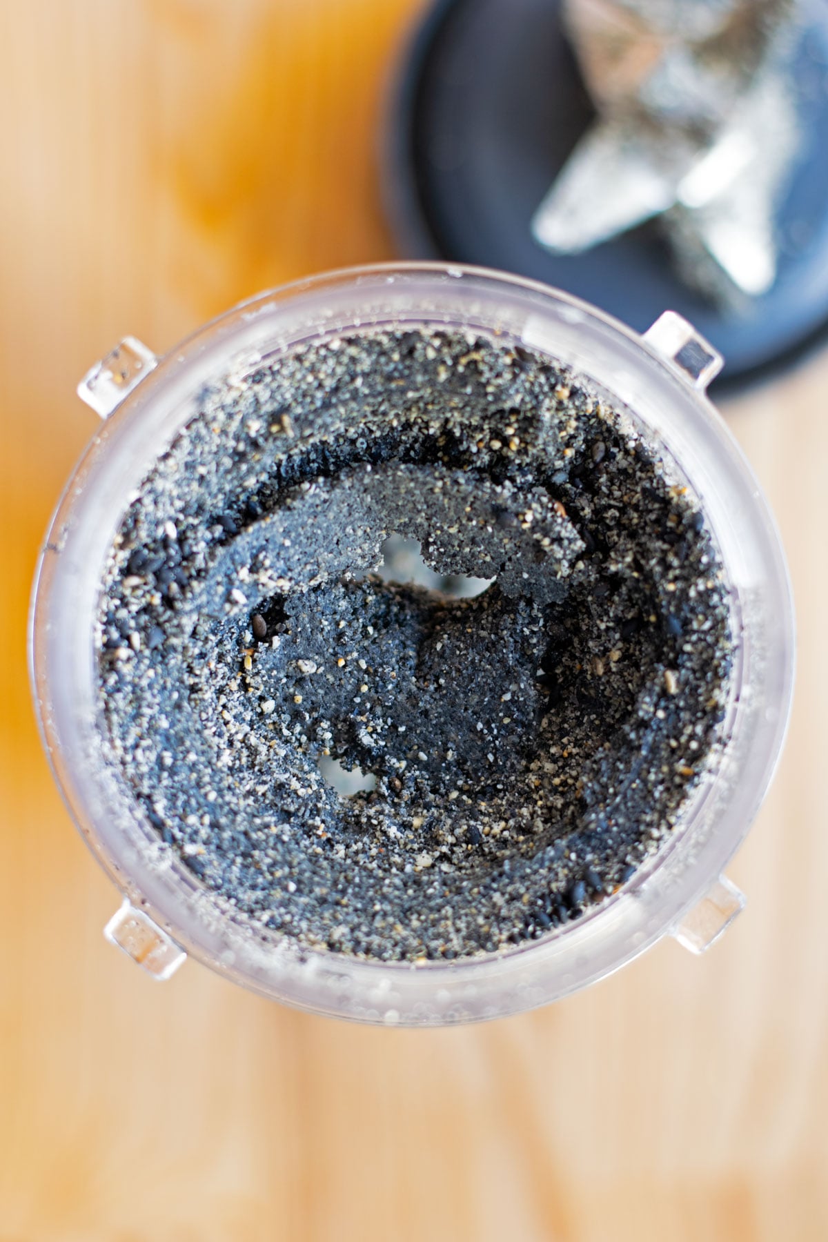 Ground black sesame seeds in blender before oils release.