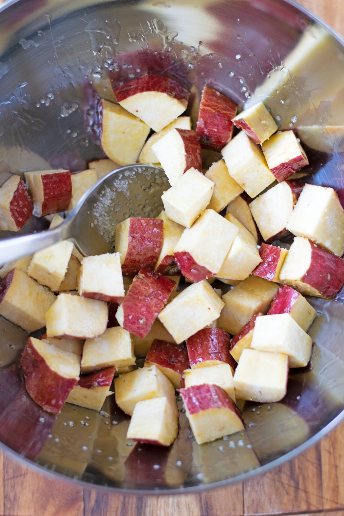 Japanese sweet potato cubes tossed with olive oil and salt before air frying.