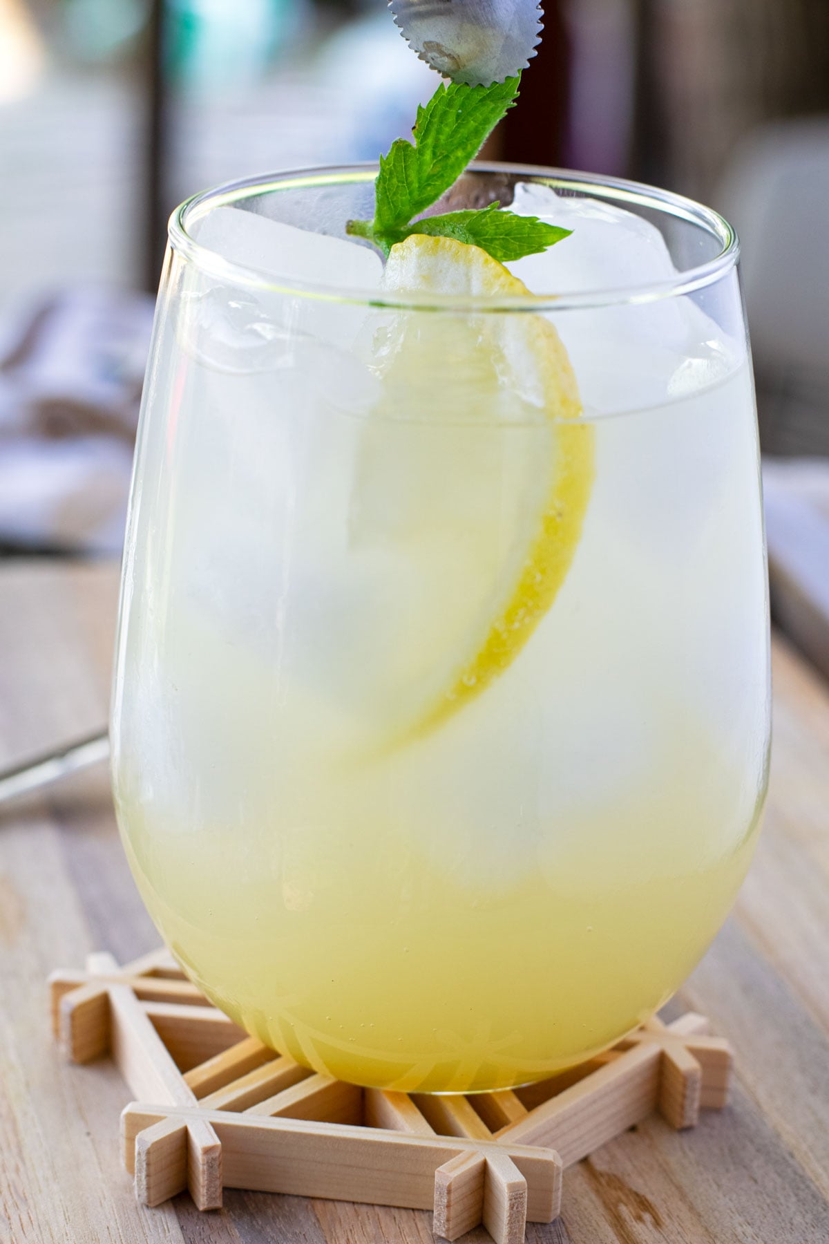 Adding fresh mint to garnish a sparkling yuzu mocktail.
