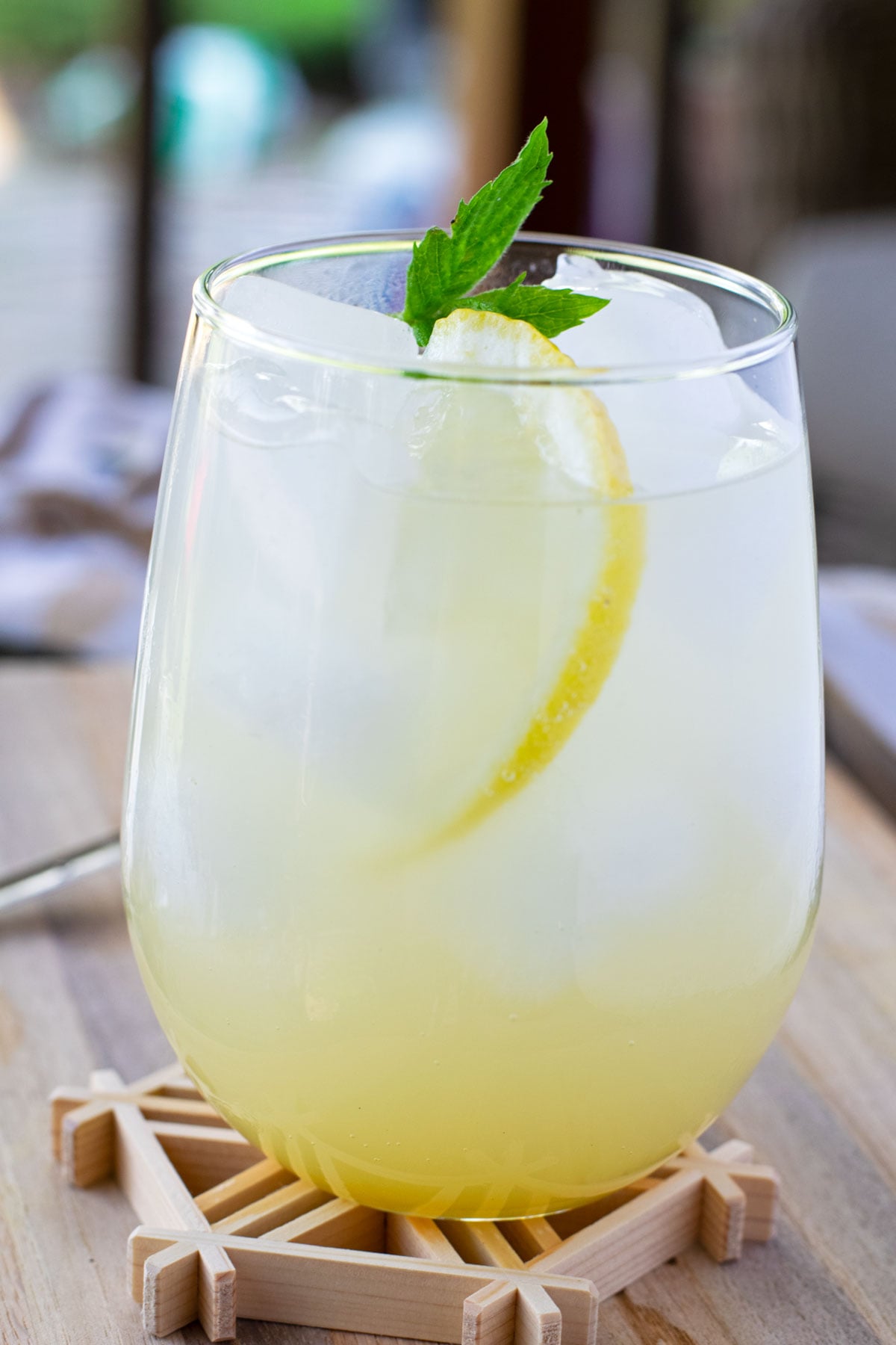 Sparkling yuzu mocktail garnished with fresh mint and a thin slice of lemon.