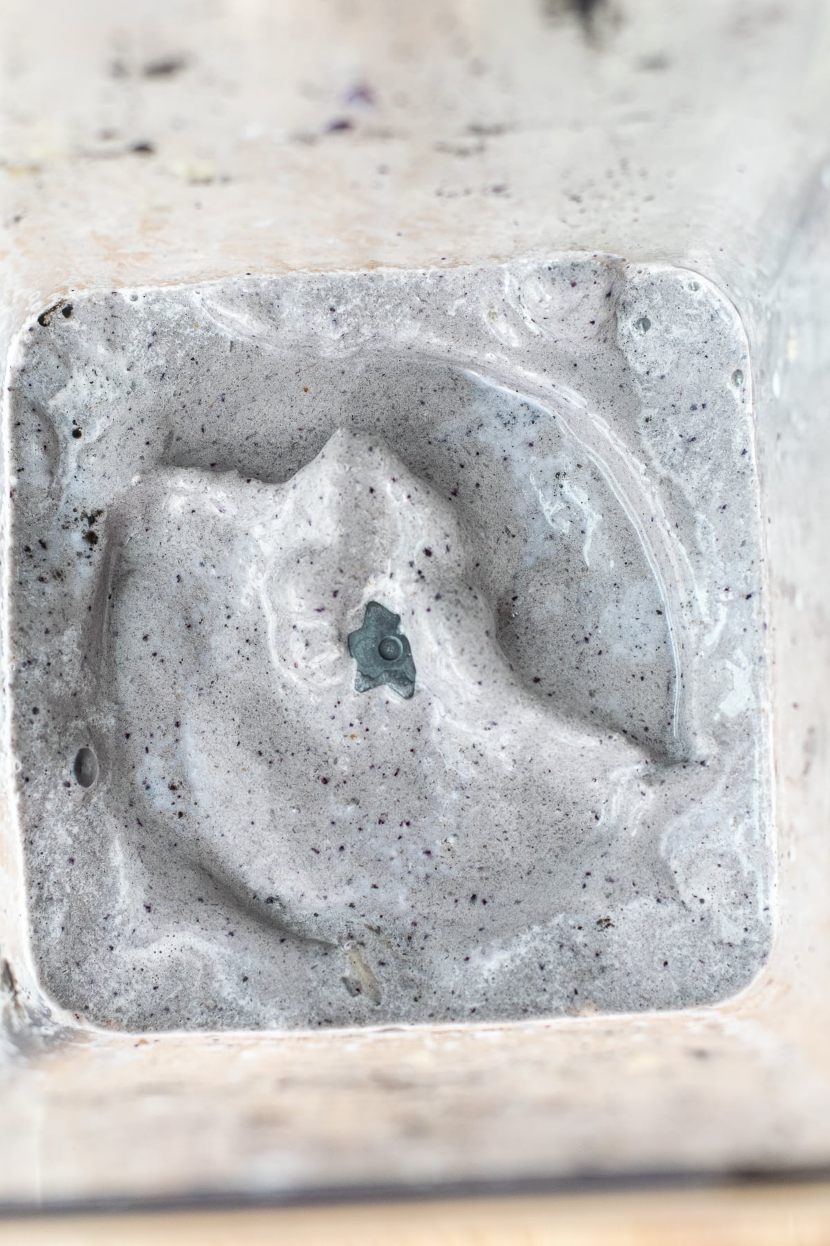 Black sesame smoothie inside blender just after blending.