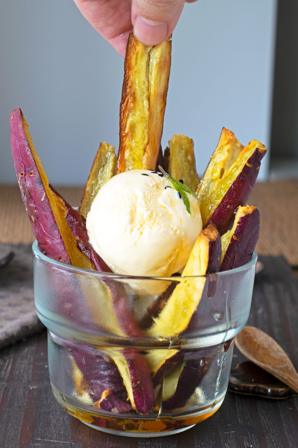 Dipping caramelized Japanese sweet potato fry into scoop of vanilla ice cream.