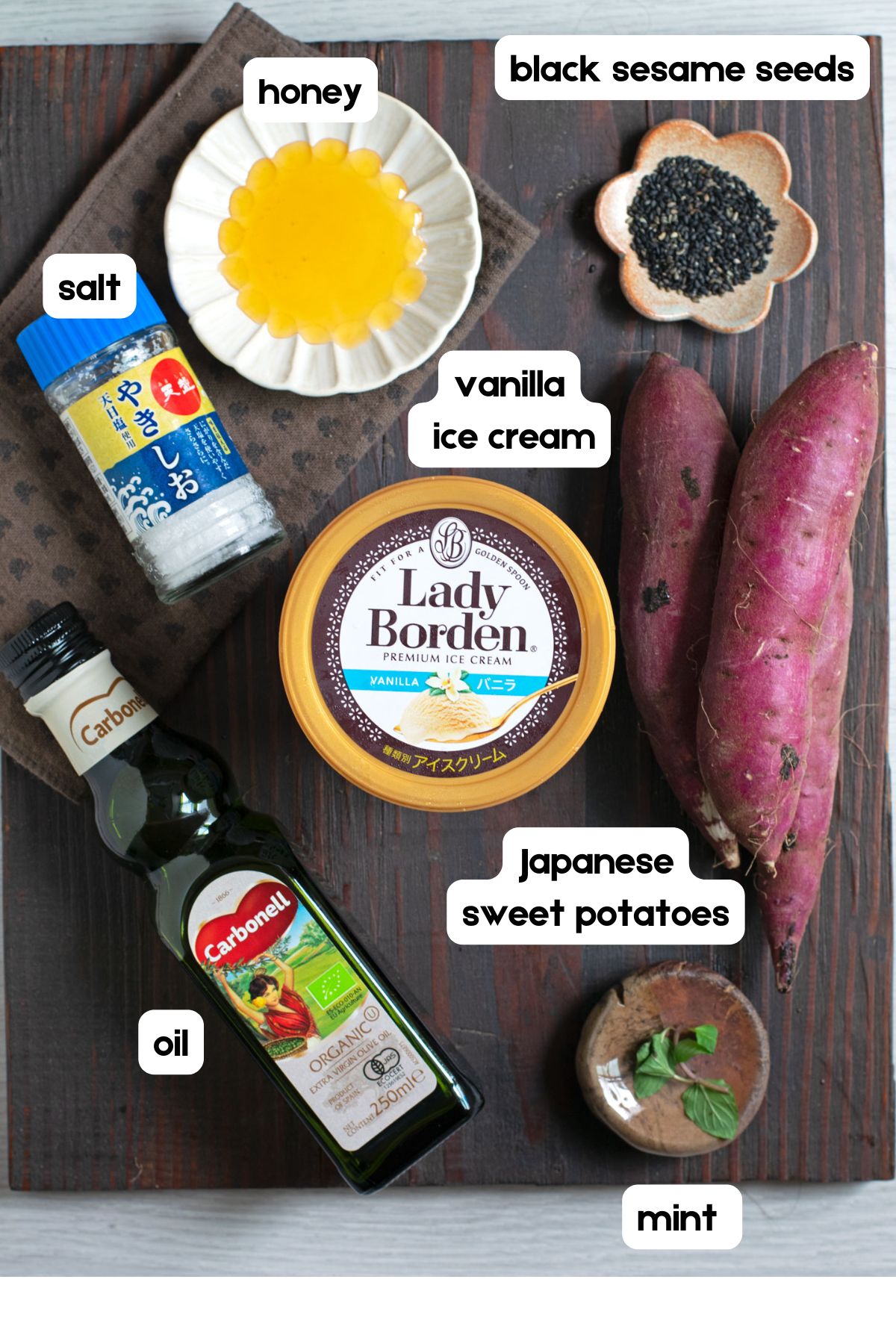 Ingredients to make yakiimo aisu: honey, black sesame seeds, salt, vanilla ice cream, Japanese sweet potatoes, oil, and mint.